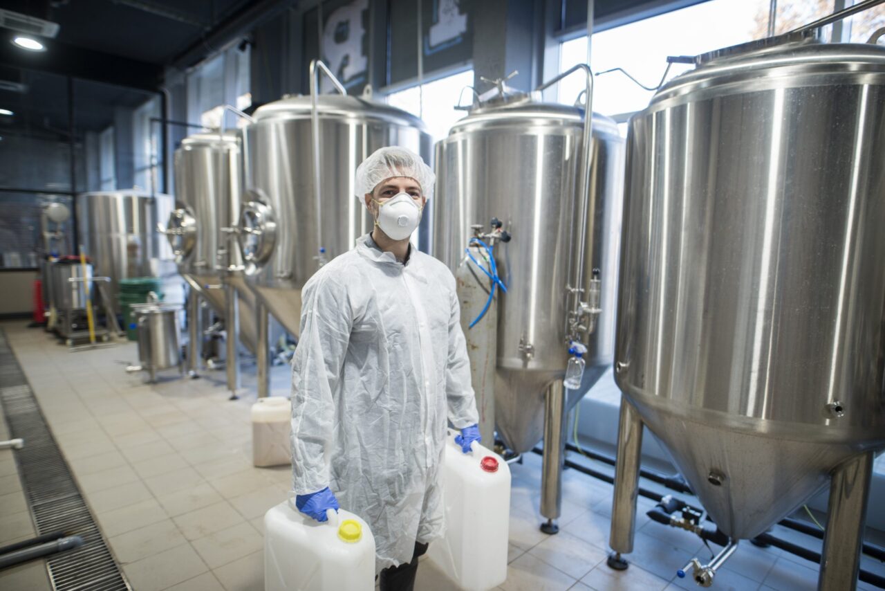 Industrial Worker Technologist In White Protective Suit
