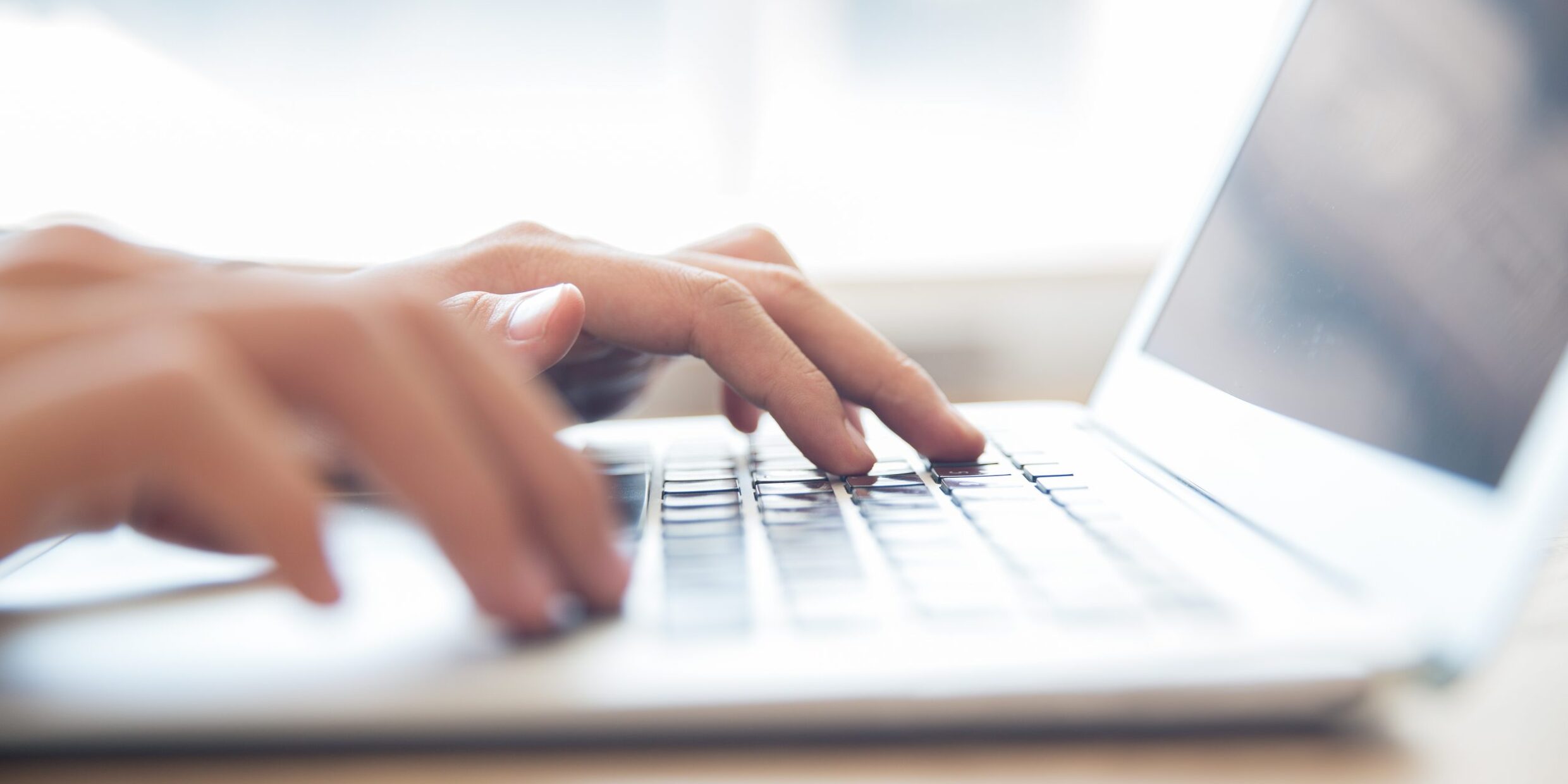 Close Up Of Male Hands Typing On Laptop Keyboard