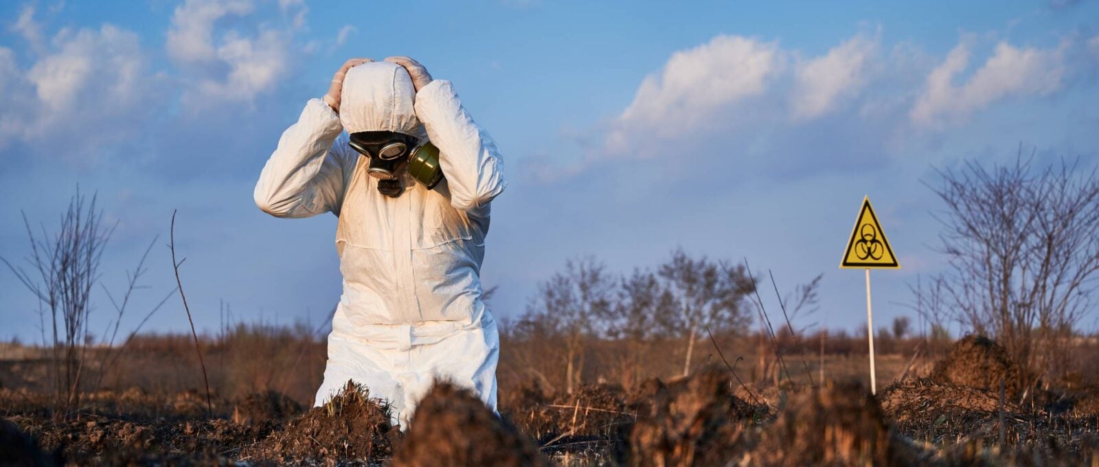 Ecologist Standing His Knees Field With Burnt Grass