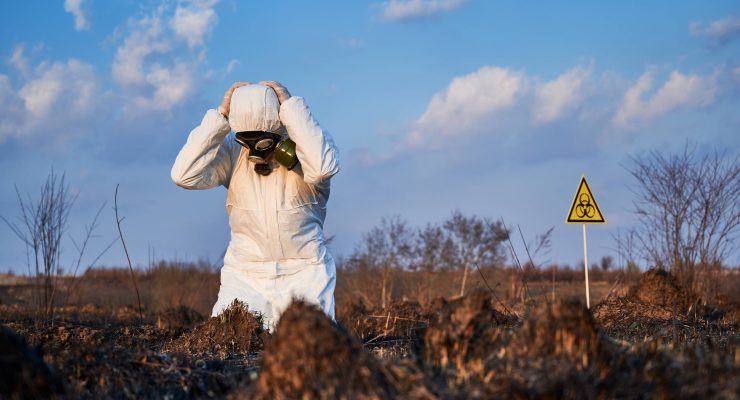 Ecologist Standing His Knees Field With Burnt Grass